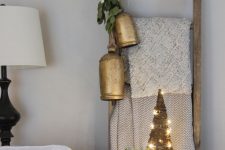greenery and vintage oversized bells are amazing to style a ladder or any other piece in your space and make it Christmassy