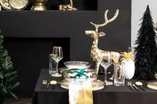 luxurious Christmas styling with gold bowls and dishes, gold deer and gold rimmed glasses and chargers is amazing
