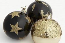 stylish black and white ornaments with gold glitter touches are a cool solution for winter holidays