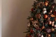 02 a bold woodland glam Christmas tree with copper and brown ornaments, sequin pinecones, lights, leaves and owls hanging