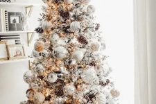 03 a breathtaking winter wonderland Christmas tree with white and silver ornaments, lights, pinecones and branches is a gorgeous idea