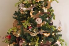 03 a bright woodland Christmas tree with mushrooms, owls, little forest animals, lights, greenery, neutral ribbons is cool