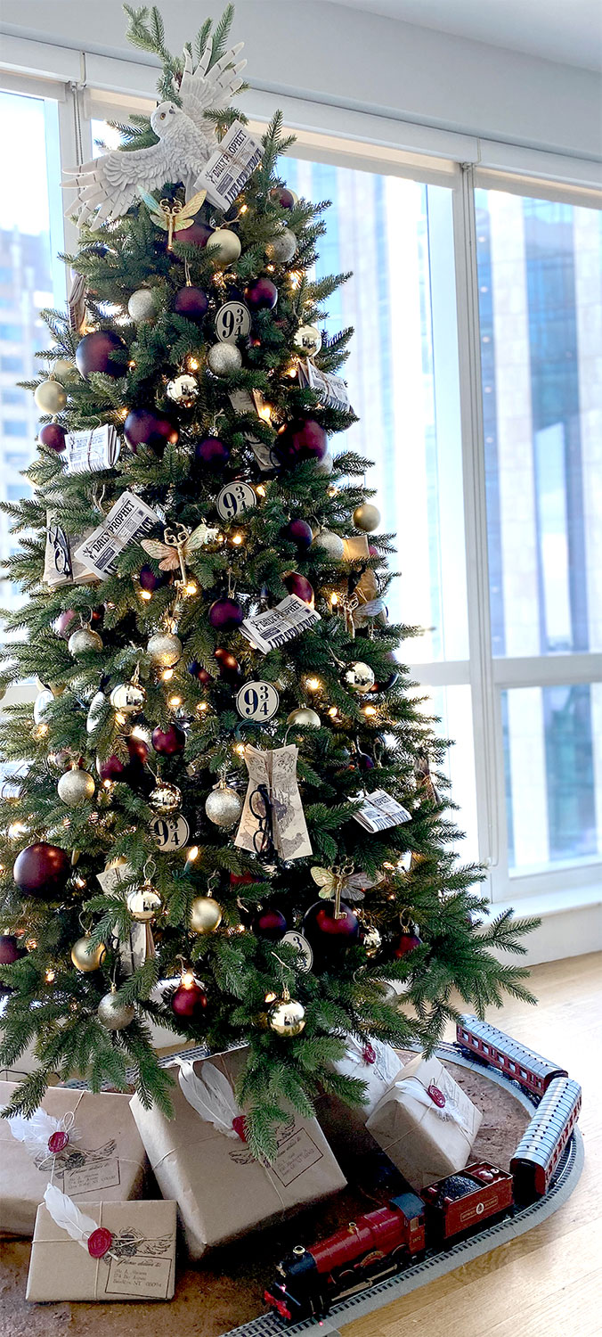 a fabulous Harry Potted inspired Christmas tree with deep purple, silver and gold ornaments, newspapers, owls, glasses and lights