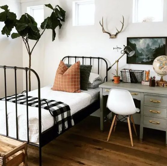 a woodland-inspired guest bedroom with a desk by the bed to use it as a nightstand too