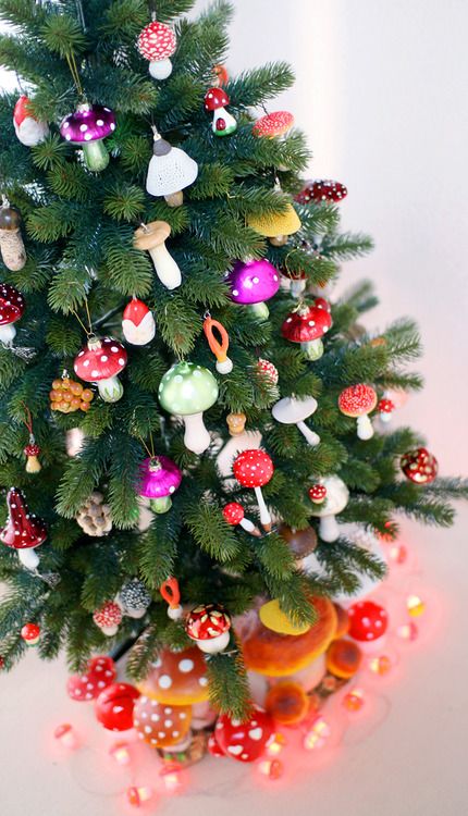 a Christmas tree decorated with lots of colorful mushrooms and berries is a fin and cool idea for a woodland celebration