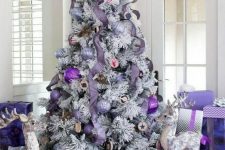 04 a flocked Christmas tree with lavender ribbons, lilac, silver and bold purple ornaments and lots of gift boxes and bags