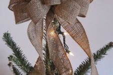 05 a large burlap bow is a great Christmas tree topper with a strong rustic or woodland feel, and you can DIY it easily