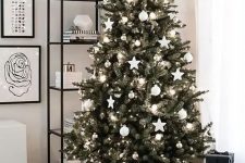 06 a classic Christmas tree decorated with only white and silver ornaments and lights and placed into a basket is a fresh and modern Scandi-inspired idea to try