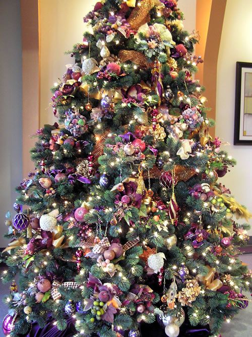 a gorgeous sophisticated Christmas tree with pink, purple, silver ornaments, plaid ribbons, beads and lights is fantastic
