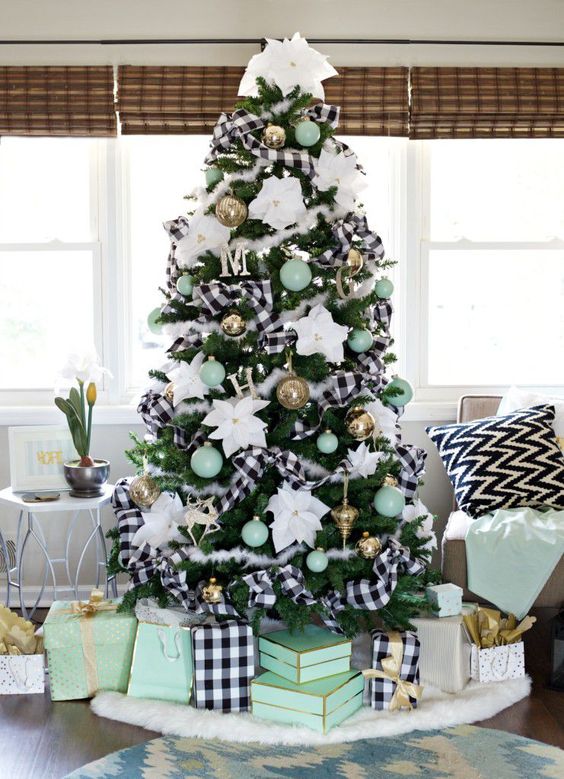 a bright Christmas tree with buffalo check ribbons, gold and mint ornaments, white fabric blooms all over is dreamy