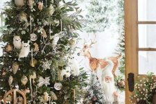 07 a forest Christmas tree decorated with greenery, white baubles, owls, pinecone ornaments and branches plus bear and deer around