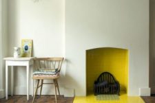07 a minimalist non-working fireplace with yellow tiles inside and out that brings a warm feeling to the space