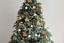 08 a creative Christmas tree with pinecones, wooden beads, white clay stars and plywood houses that make a statement