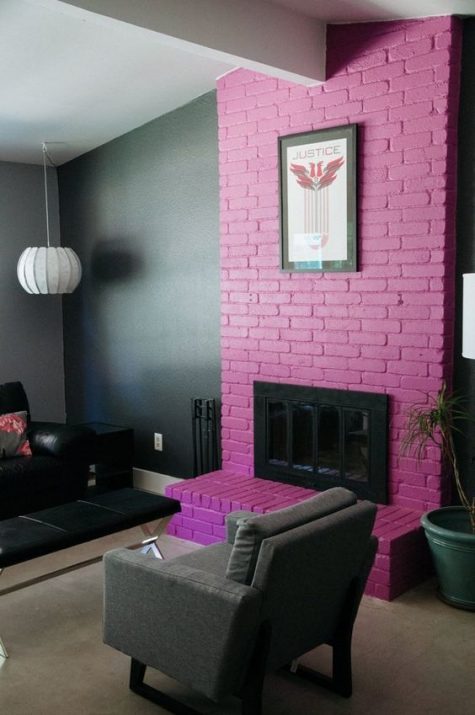 a moody living room with a hot pink brick fireplace that brings much color and makes the space playful