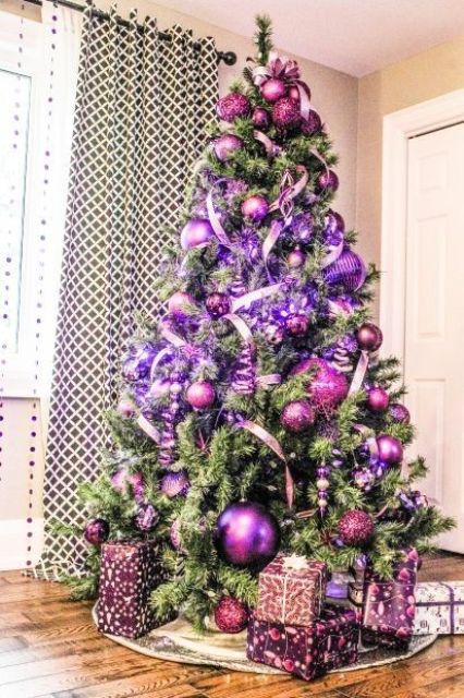 a shiny and glam Christmas tree with fuchsia and purple ornaments, ribbons, lights and gifts in matching boxes is amazing