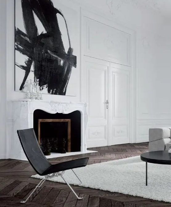 a white marble clad fireplace with black inside and a gorgoeus ornated white mantel over it, a statement artwork for a stronger impression