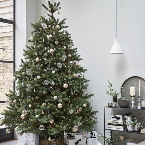 a delicate neutral Christmas tree with white, gold, silver and semi sheer ornaments, shiny stars and beads plus lights is gorgeous