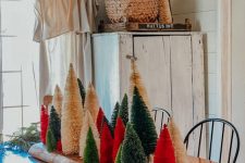 10 a wooden plank with a colorful bottle brush tree forest is a gorgeous and fresh Christmas centerpiece idea