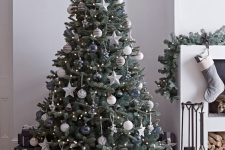 11 a dreamy Christmas tree with lights, graphite grey and silver and white ornaments, stars, bells and baubles is a very refined idea