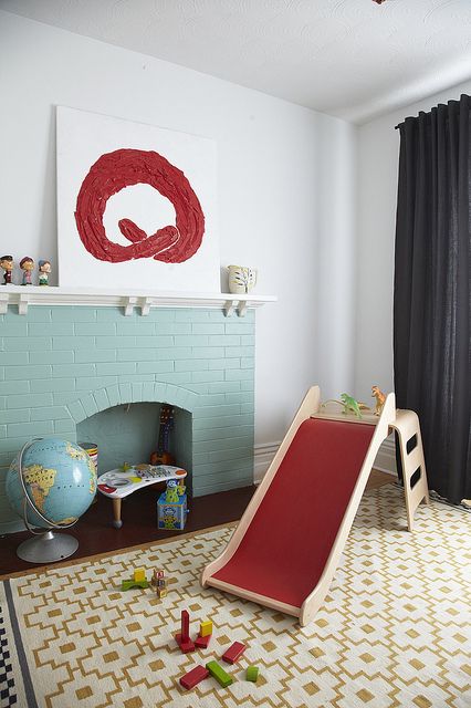 a non-working mint blue brick fireplace finishes off the playroom making it cozier and more welcoming