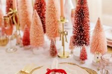 11 a sophisticated Christmas tablescape with red and pink bottle brush trees, pink candles, woven placemats and pink porcelain