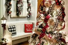 11 an eye-catchy Christmas tree with burlap and buffalo check ribbons and lights plus berries is a very chic and cool idea for a farmhouse