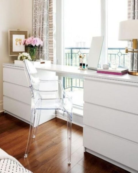 a modern white desk made of a couple of IKEA Malm dressers and a tabletop is a creative piece with plenty of storage