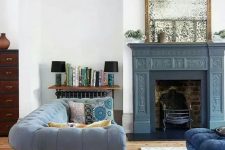 a cute neutral living room design with an antique fireplace