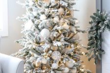 a stylish flocked Christmas tree with snowballs