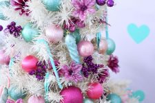 14 a white Christmas tree with blush, pink, aqua and purple ornaments, beads and purple fabric blooms is a fantastic idea