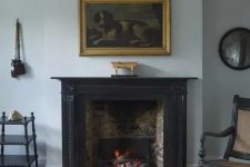 a stylish brick fireplace with a black mantel