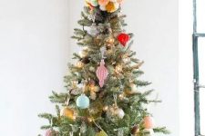 16 a colorful pompom Christmas tree topper matches the colorful decor fo the tree and adds fun to the decor