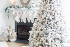 16 a magical flocked Christmas tree with gold, white and silver ornaments, pinecones, greenery, lights and grasses is amazing