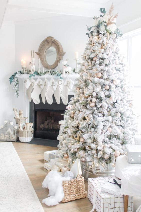 a magical flocked Christmas tree with gold, white and silver ornaments, pinecones, greenery, lights and grasses is amazing