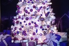 16 a white Christmas tree with deep purple, lilac and bold purple ornaments of various shapes that looks amazing