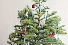 17 a creative Christmas tree with fun elf figurines, letters, sheer ornaments, apples and other stuff plus a creative owl tree topper