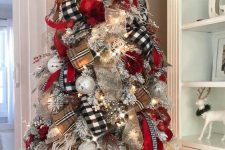17 a flocked Christmas tree decorated with gold mesh, tan plaid and buffalo check ribbons, lights, berries and white ornaments