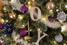 17 glam and shiny Christmas tree decor with glitter letters, purple, gold and silver ornaments, garlands and snowflakes