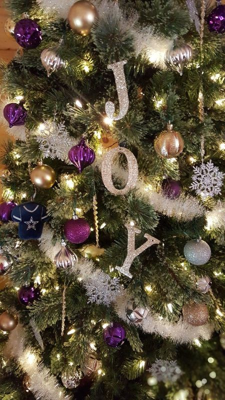 glam and shiny Christmas tree decor with glitter letters, purple, gold and silver ornaments, garlands and snowflakes