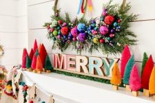 18 an extra bold Christmas mantel with bright bottle brush trees, letters, a wreath with ornaments and greenery, felt balls and wooden Christmas trees