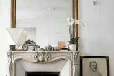 19 a chic vintage fireplace with an ornated mantel, some pretty mantel decor, an oversized mirror and some books