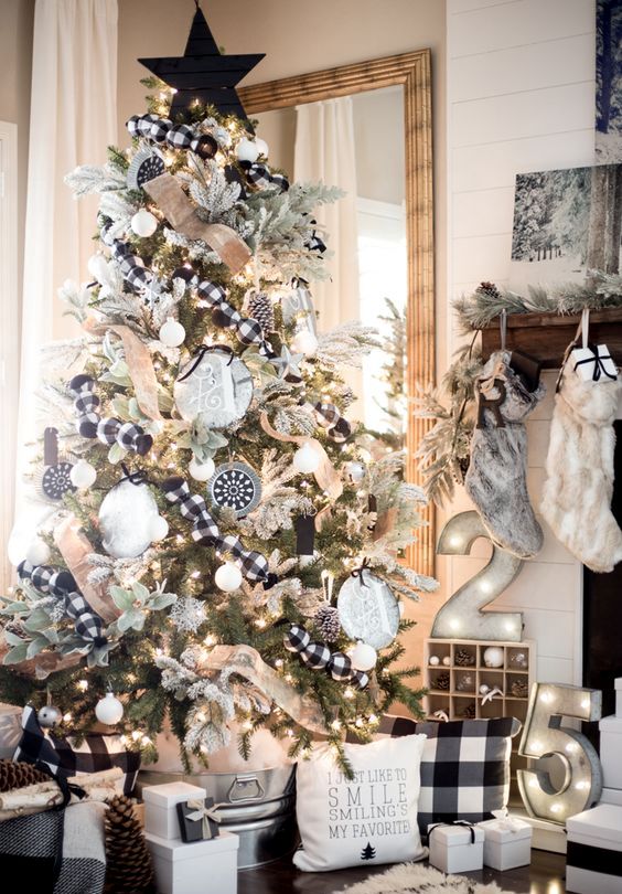 a farmhouse Christmas tree with burlap and buffalo check ribbons, oversized monograms and snowy pinecones, a black planked star topper