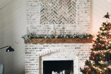 20 a stylish whitewashed brick fireplace with a wooden mantel with greenery and candles looks very stylish and rustic