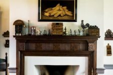 21 a gorgeous vintage fireplace with a jaw-dropping vintage stained ornated wooden mantel, with stylish decor and a bold artwork