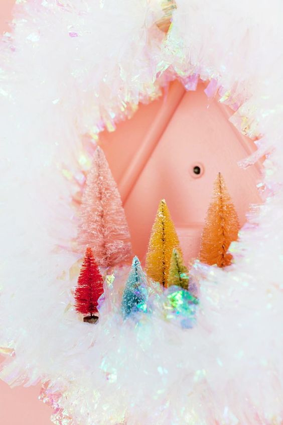 a shiny cellophane Christmas wreath with colorful bottle brush trees for decor is amazing for a modern space
