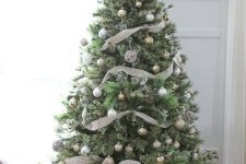 21 a subtle neutral Christmas tree with gold, silver and light green ornaments, lights, plaid ribbons and vine ornaments is a chic idea
