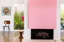 22 a modern white brick fireplace with a bright plain pink accent over it is a beautiful color feature in this mid-century modern space