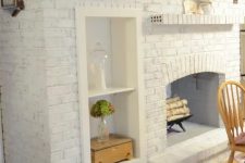 22 an oversized whitewashed brick non-working fireplace with built-in shelves and potted greenery is a stylish and cozy decoration