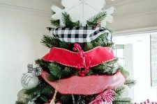 23 a large white plywood snowflake tree topper is a perfect match for this cool and bright farmhouse Christmas tree