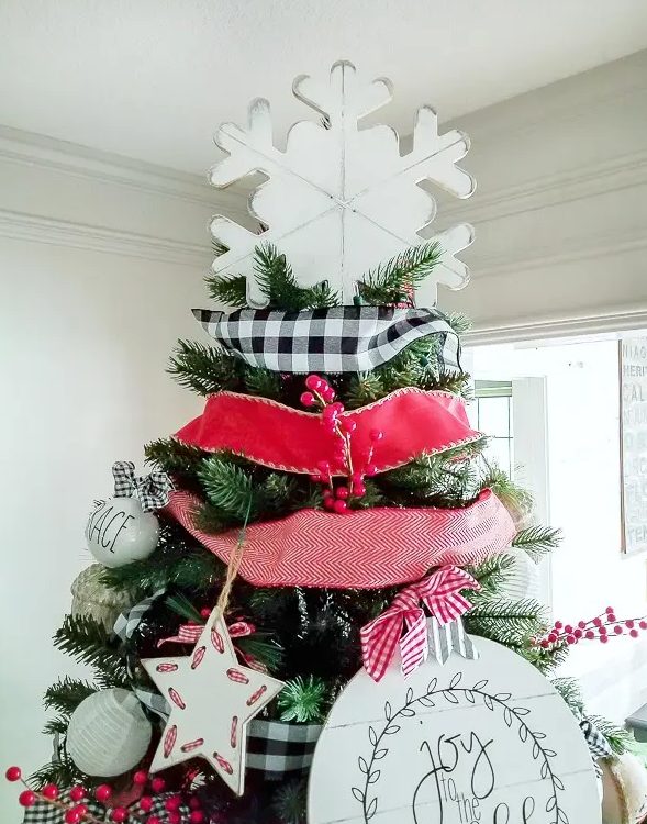 a large white plywood snowflake tree topper is a perfect match for this cool and bright farmhouse Christmas tree